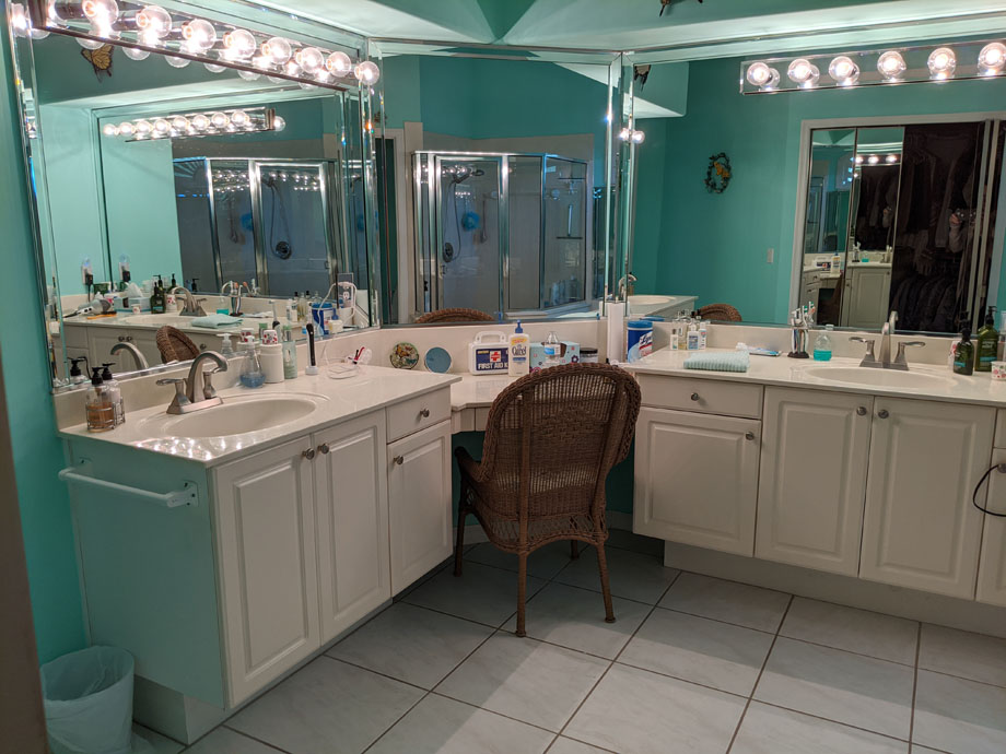 before shot of "Gulick Bath" with teal blue walls, white counters and cabinets